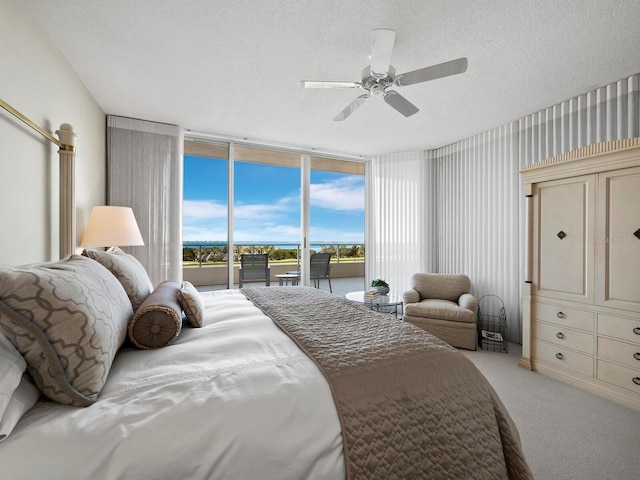 bedroom with ceiling fan, a textured ceiling, light carpet, access to outside, and expansive windows