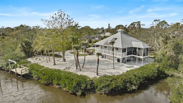 rear view of property with a sunroom and a water view