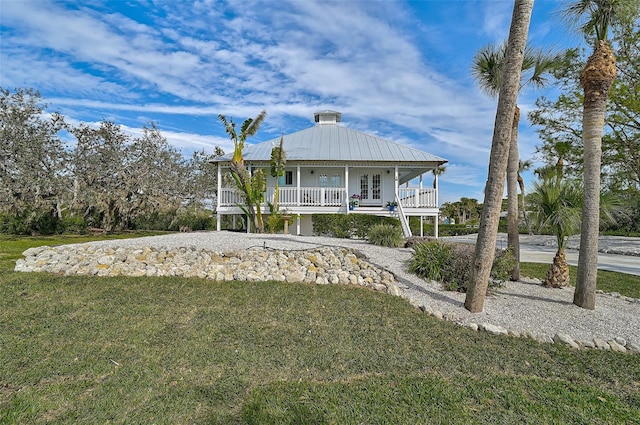 view of front of home featuring covered porch and a front yard