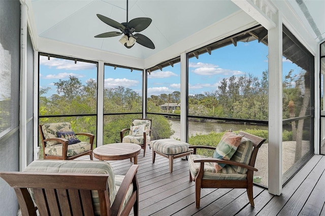 sunroom featuring ceiling fan, a water view, and a wealth of natural light