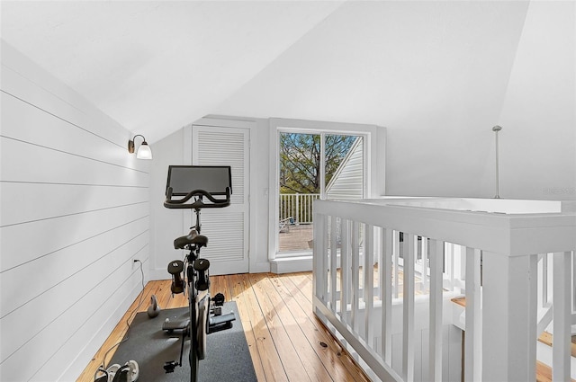 exercise area featuring vaulted ceiling and hardwood / wood-style floors