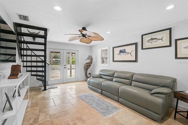 living room with ceiling fan, a textured ceiling, and french doors