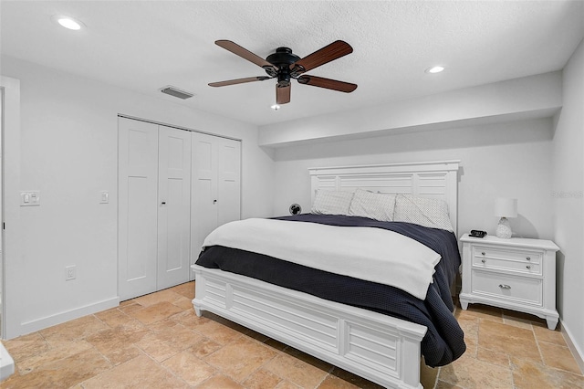 bedroom with ceiling fan and a closet