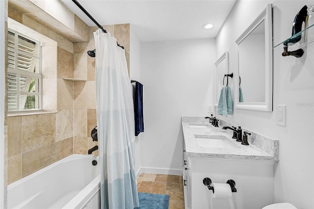 bathroom featuring shower / tub combo and vanity