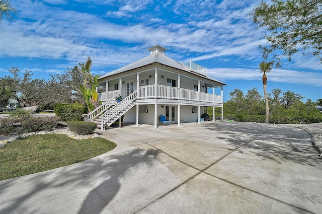 view of front of home with a porch and a carport