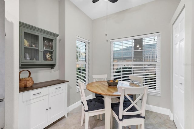 dining room with ceiling fan and light tile patterned flooring