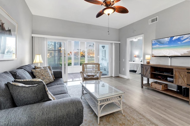 living room featuring ceiling fan and light hardwood / wood-style flooring