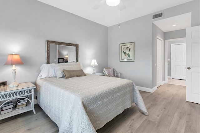 bedroom with hardwood / wood-style flooring, ceiling fan, and a closet