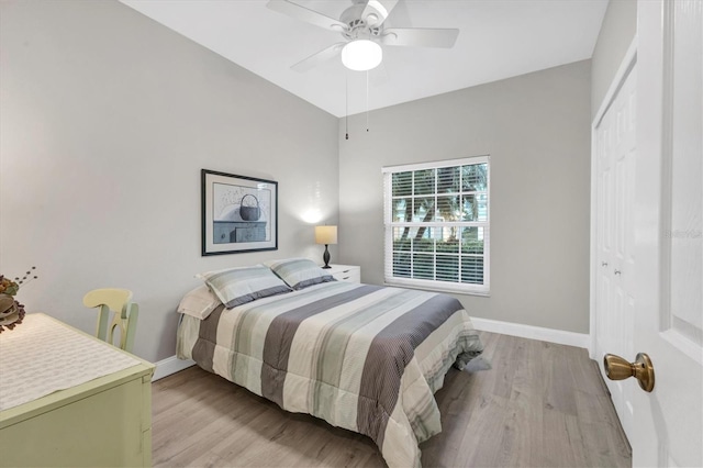 bedroom featuring ceiling fan, a closet, and light wood-type flooring