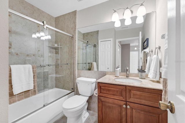 full bathroom with combined bath / shower with glass door, tile patterned floors, vanity, an inviting chandelier, and toilet