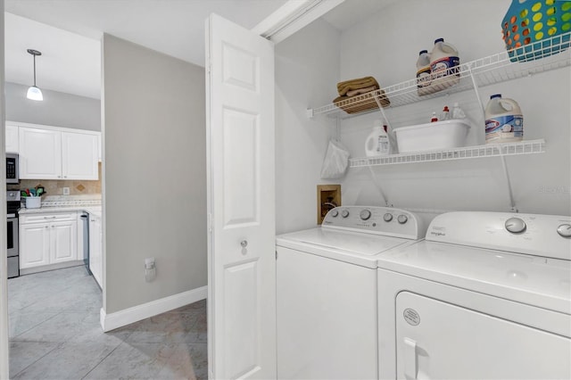 laundry room featuring light tile patterned floors and washer and dryer