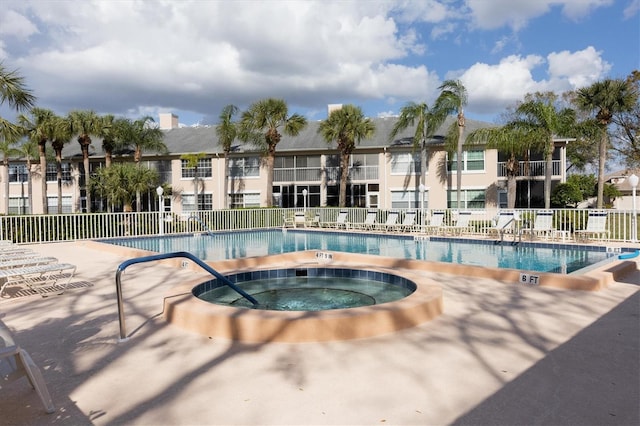 view of swimming pool featuring a hot tub