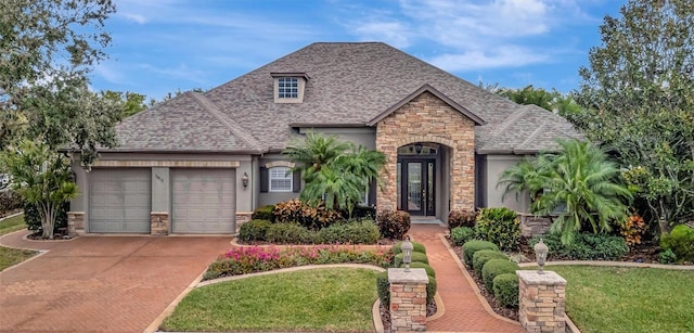 view of front of home with a front yard and a garage