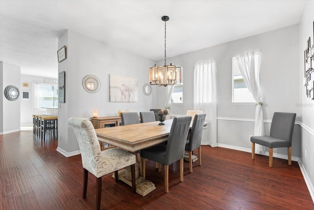 dining room featuring dark wood-type flooring and a notable chandelier