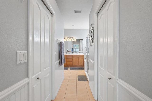 hall with light tile patterned flooring