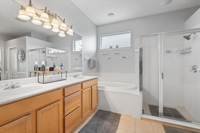 bathroom featuring tile patterned floors, vanity, and shower with separate bathtub