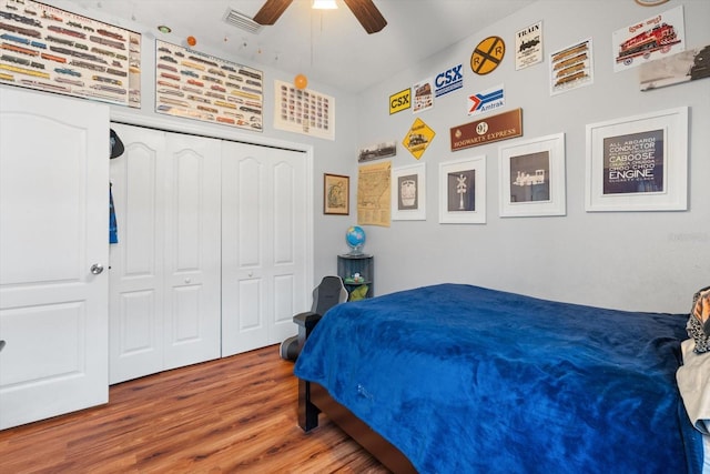 bedroom with a closet, ceiling fan, and hardwood / wood-style flooring