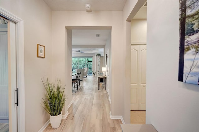 hallway with light hardwood / wood-style flooring