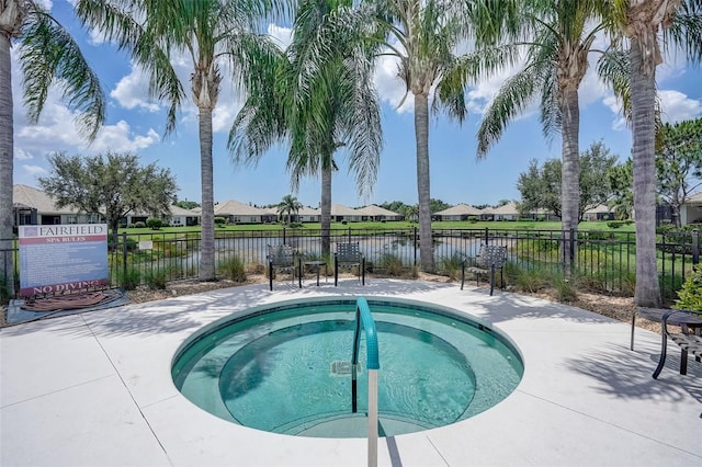 view of swimming pool featuring a community hot tub and a water view