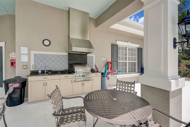 view of patio / terrace featuring grilling area, sink, and an outdoor kitchen