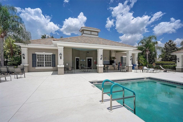 back of house featuring a patio area and a community pool