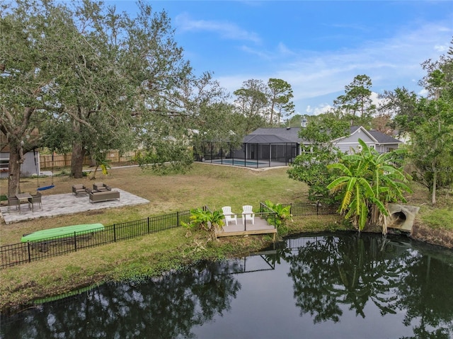 exterior space with a lanai, a pool side deck with water view, a patio, and an outdoor fire pit