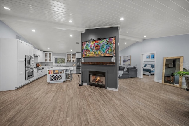 living room featuring vaulted ceiling with beams, wood ceiling, and light wood-type flooring