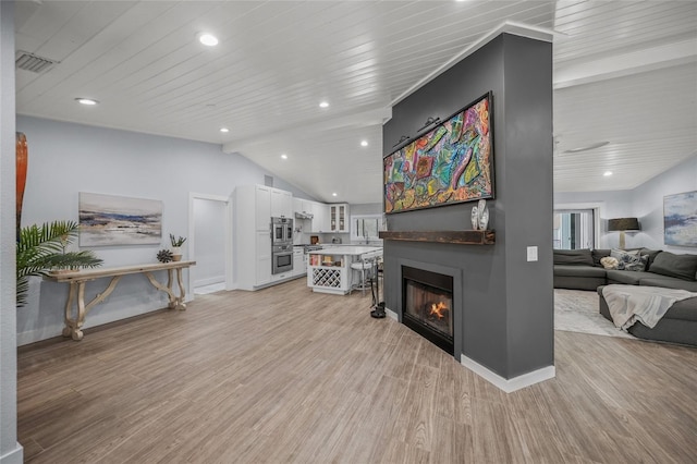 living room featuring lofted ceiling, wooden ceiling, and light wood-type flooring