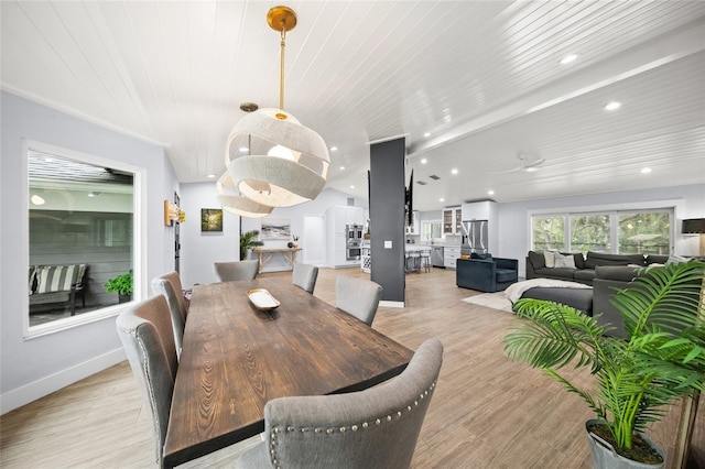 dining room with wooden ceiling and light wood-type flooring