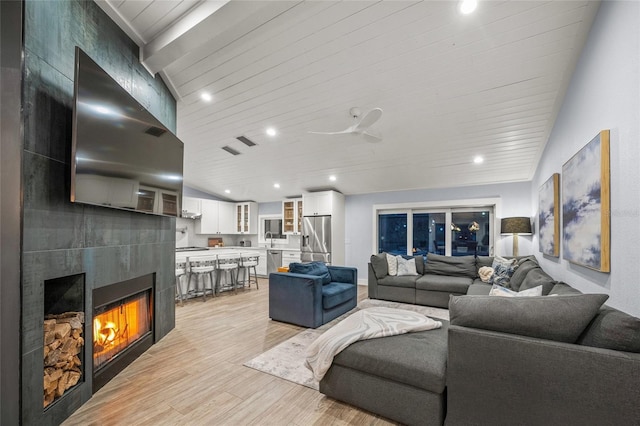 living room with lofted ceiling, a fireplace, light hardwood / wood-style flooring, and wooden ceiling