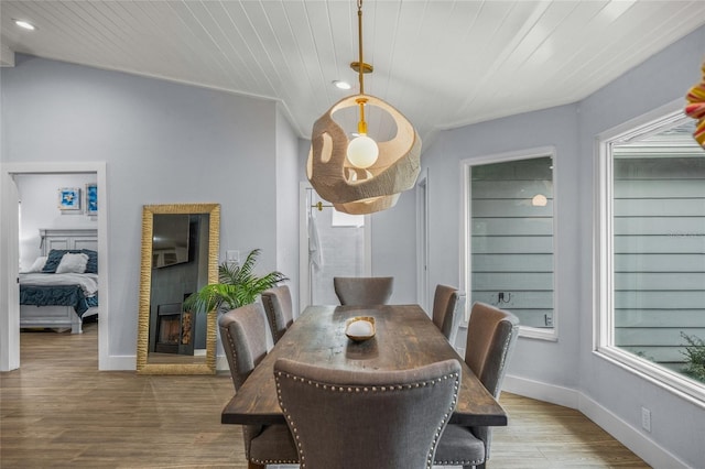 dining space with wood ceiling and wood-type flooring