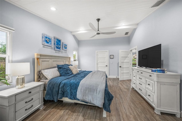 bedroom with ceiling fan, lofted ceiling, dark hardwood / wood-style flooring, and multiple windows