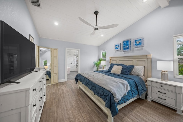 bedroom featuring hardwood / wood-style flooring, ceiling fan, lofted ceiling, and ensuite bathroom