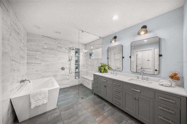 bathroom featuring vanity and separate shower and tub