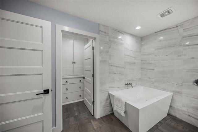 bathroom featuring a tub to relax in