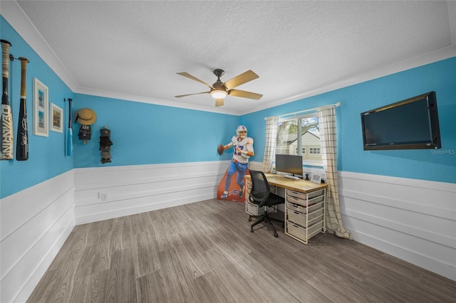 office area featuring hardwood / wood-style flooring, crown molding, ceiling fan, and a textured ceiling