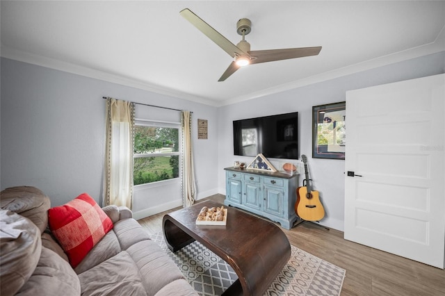 living room with crown molding, ceiling fan, and light hardwood / wood-style floors