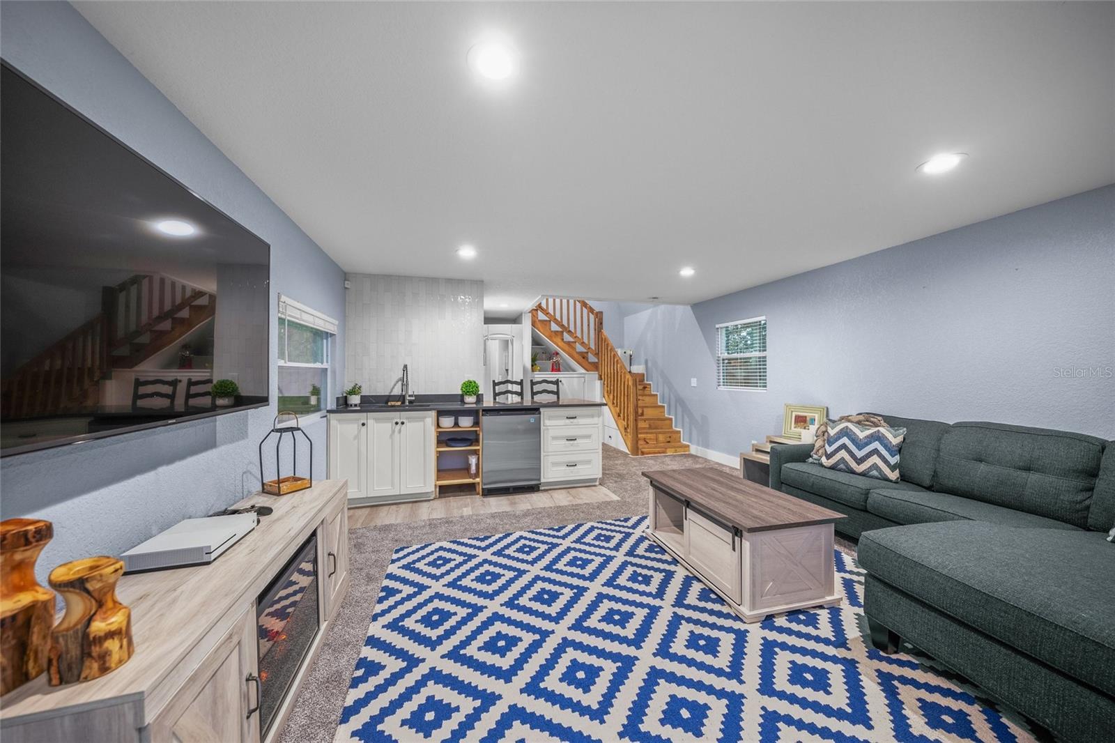 living room with sink and light hardwood / wood-style floors