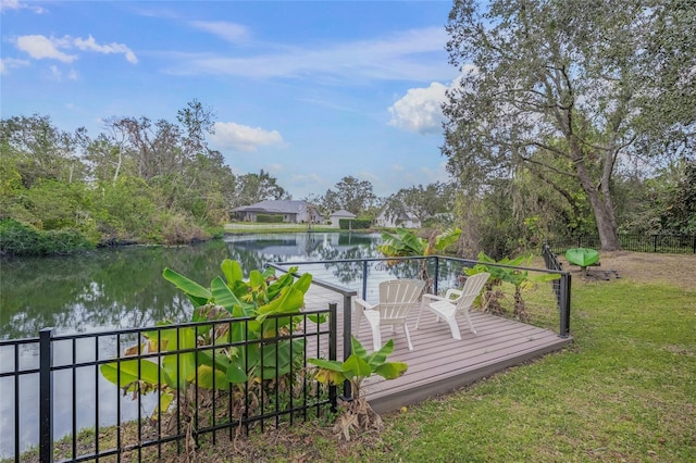 wooden deck featuring a lawn and a water view