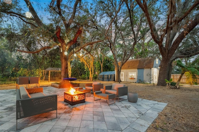 view of patio featuring a storage shed, a gazebo, and a fire pit