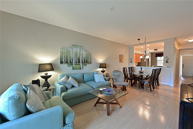 living room with a chandelier and hardwood / wood-style flooring