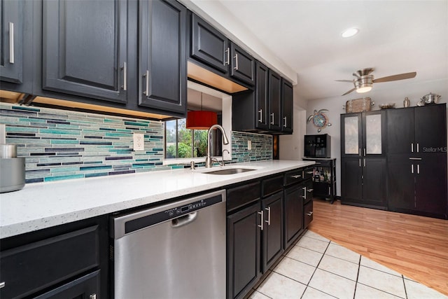 kitchen with dishwasher, tasteful backsplash, sink, ceiling fan, and light tile patterned floors