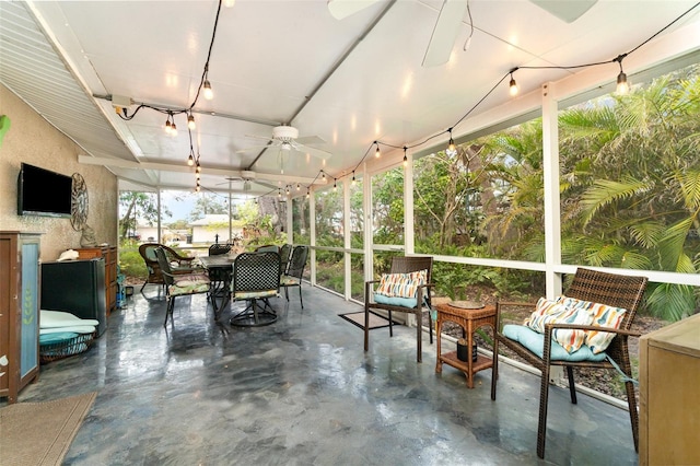 sunroom / solarium featuring ceiling fan