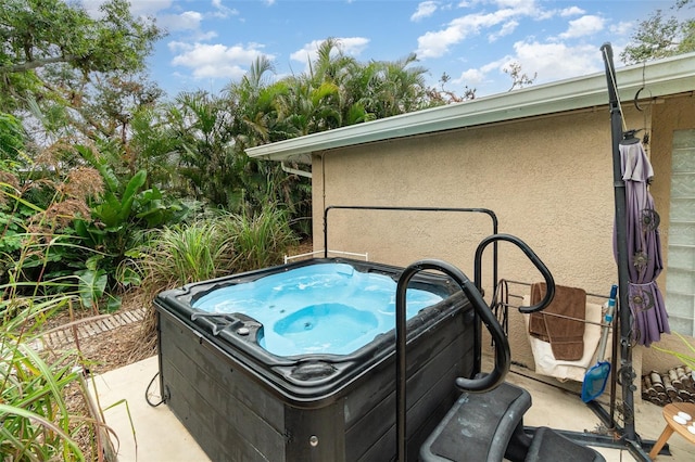 exterior space with a hot tub