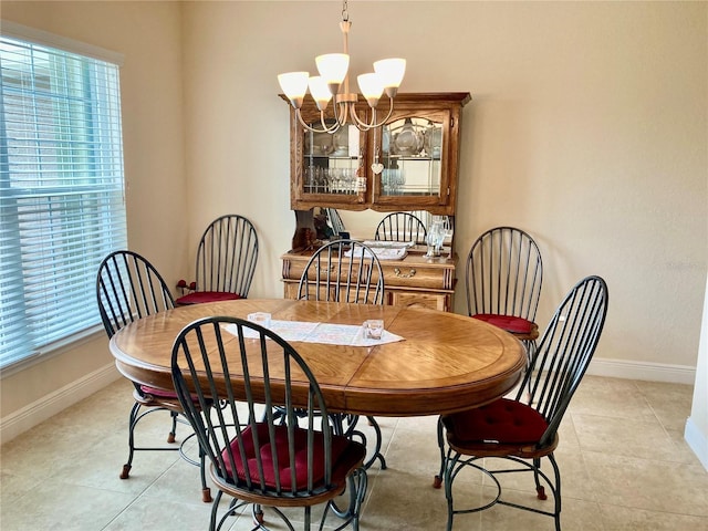 dining room with a chandelier and light tile patterned floors