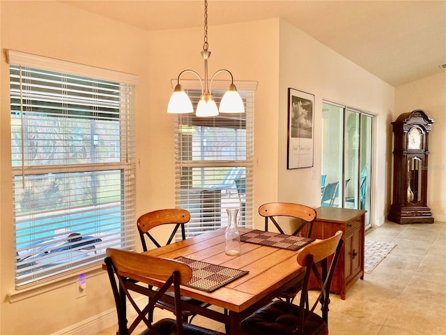 dining room with light tile patterned floors and an inviting chandelier