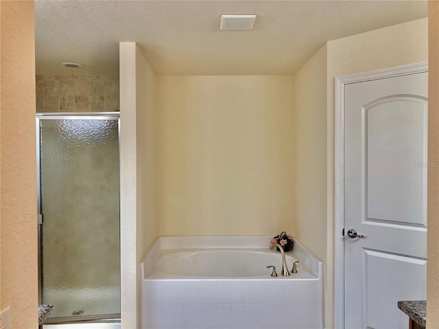 bathroom with vanity and shower with separate bathtub