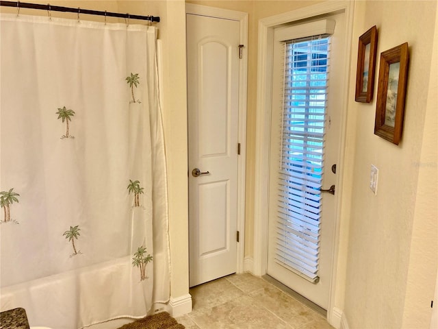 doorway to outside featuring light tile patterned flooring