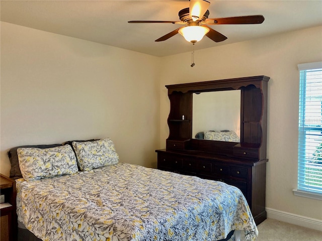 bedroom with light colored carpet and ceiling fan