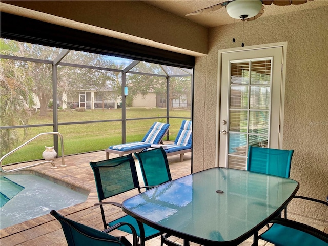 sunroom featuring ceiling fan